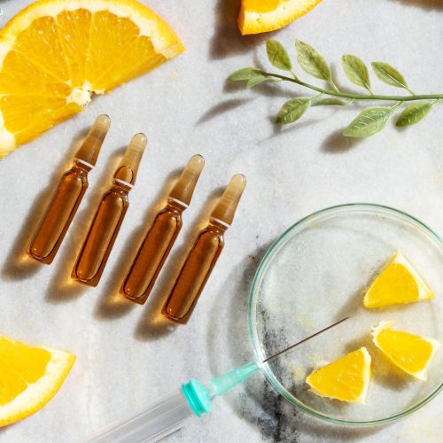 Citrus fruit vitamin c serum oil beauty care, anti aging natural cosmetic ampullas, laboratory testing concept